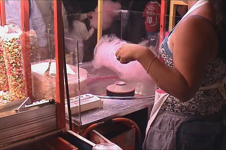 Making pink cotton candy at the fair