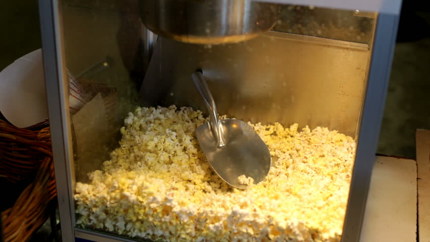 Popcorn scooped from machine
