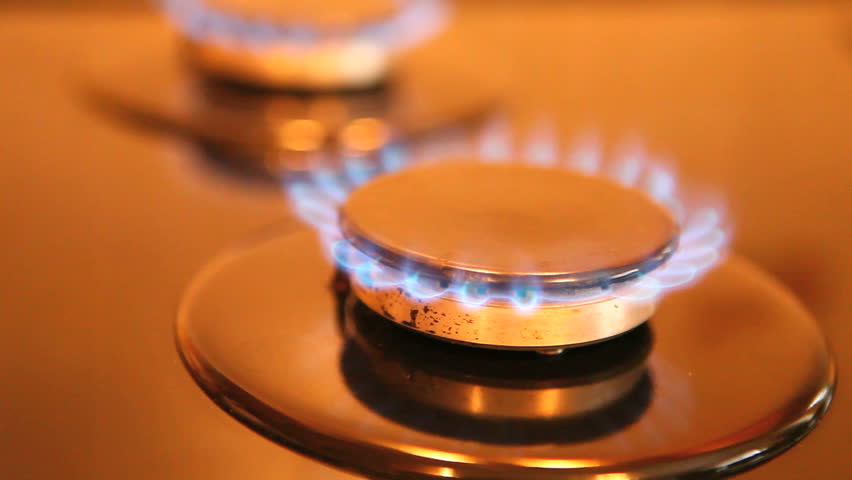Two gas ring burners on a home cooker, shallow depth of field