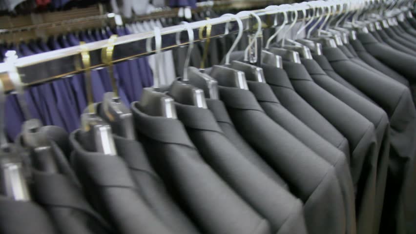 view of some identical black jackets on hangers in shop