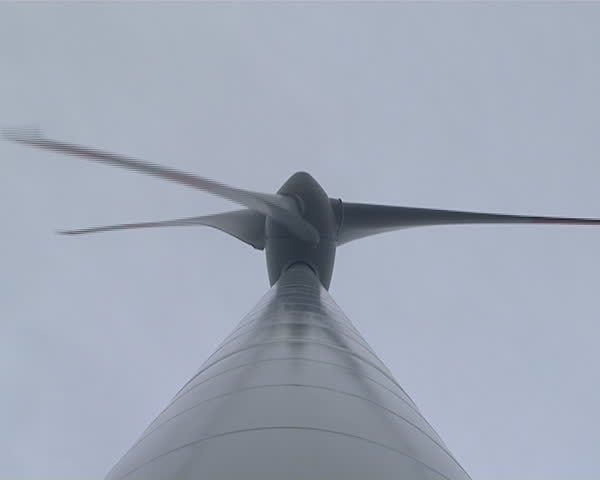 Closeup of rotating windmill propeller wings shot from bottom. 