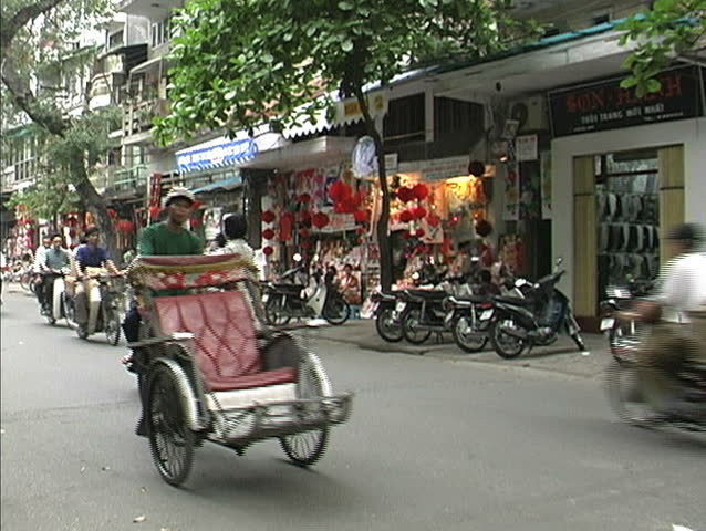 HANOI, VIETNAM - CIRCA APRIL 1998: People ride scooters circa April 1998 in Hanoi. 
. 