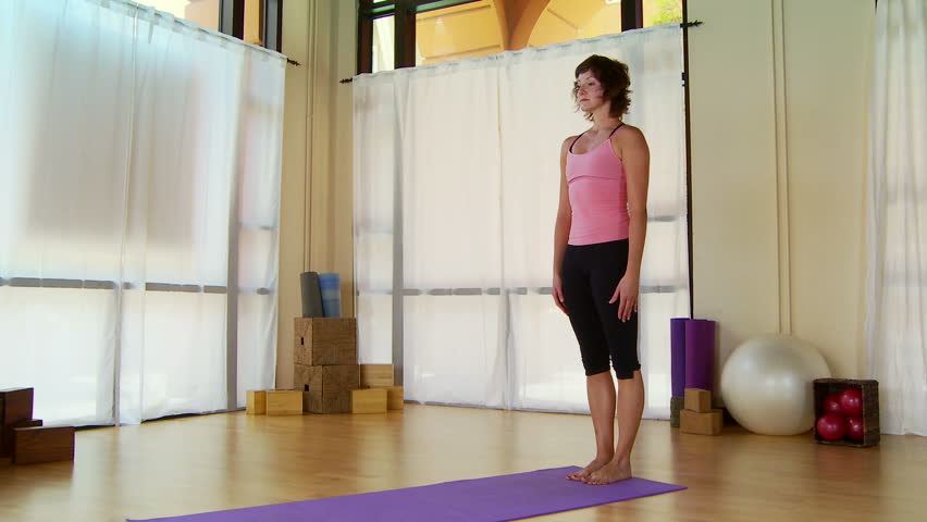 Young woman performing pilate move on a mat