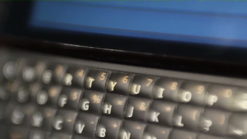 HD macro toy lens / selective focus footage of a QWERTY smart phone, with the message "WTF" being texted on it.