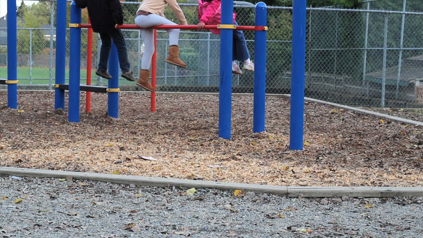 A cute little 5 year old Asian girl holds up a "stop bullying" sign trying to send a message on the school playground.