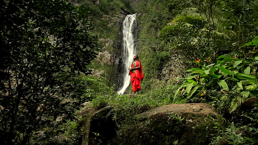 HAWAII - CIRCA 2010: Shaman against a waterfall