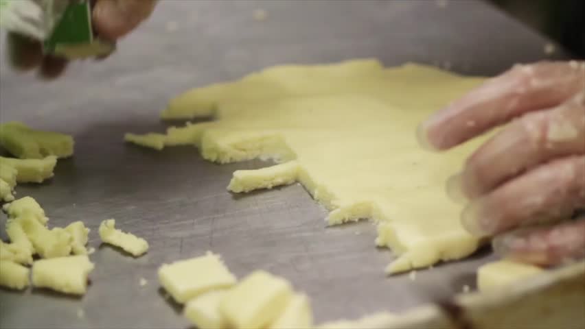 Hand Cutting Out Square Cookies From The Dough