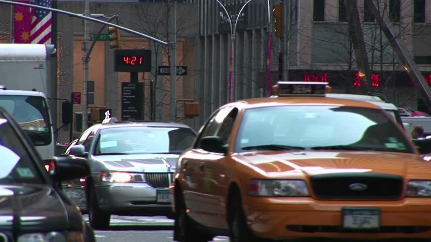 NEW YORK - CIRCA 2005: A crowded New York street scene includes heavy traffic, pedestrians, time, temperature and news marquee in New York, NY circa 2005