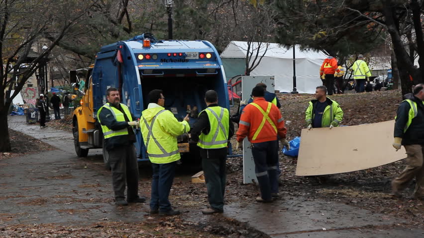 TORONTO, ONTARIO - NOV 23: City workers dismantle Occupy Toronto site on Nov 23rd, 2011, Toronto, Ontario, Canada. The site was closed down by police following a superior court judge ruling.