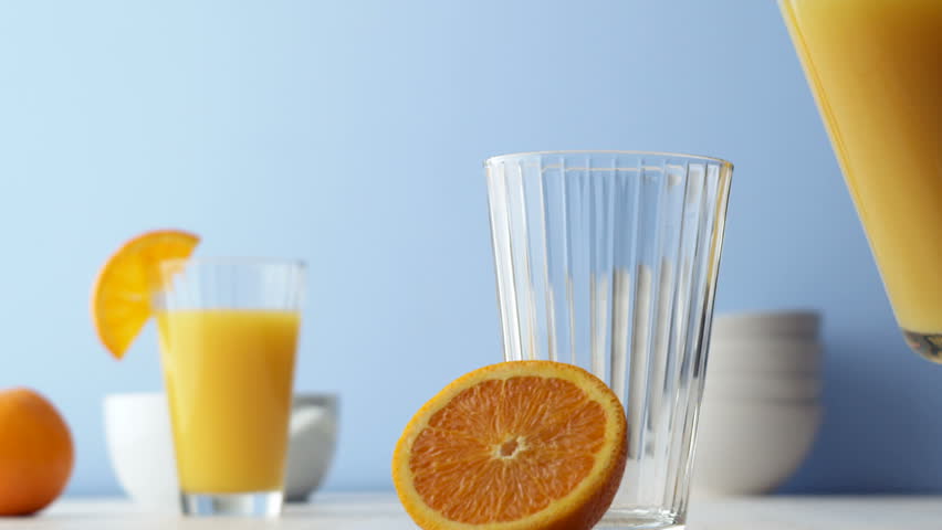 Orange juice pouring into glass