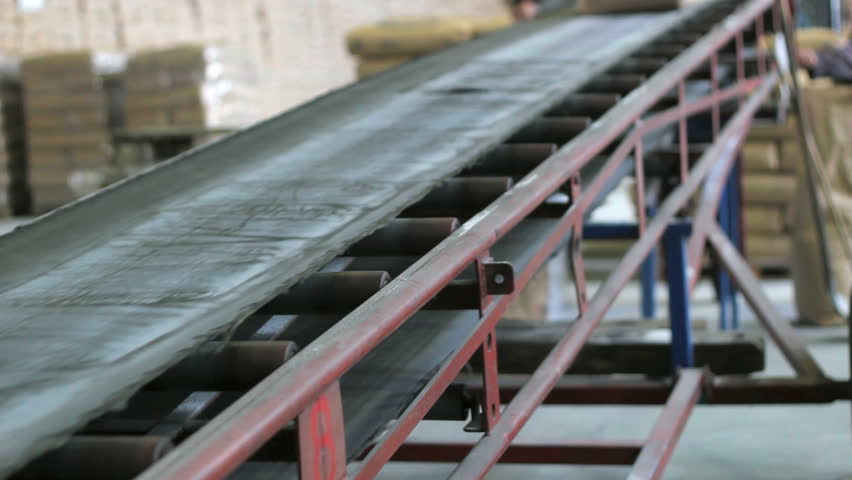 Distribution warehouse. Sacks moving along the conveyor belt in a warehouse. HD 1080i.