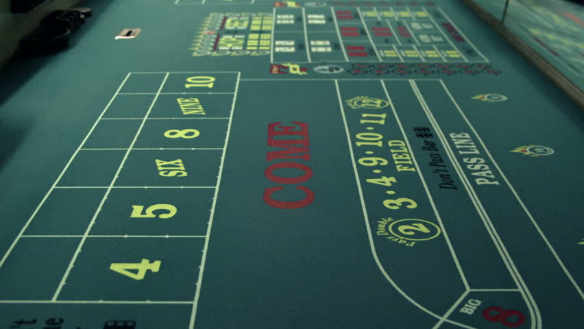 Dice rolling across a craps table.