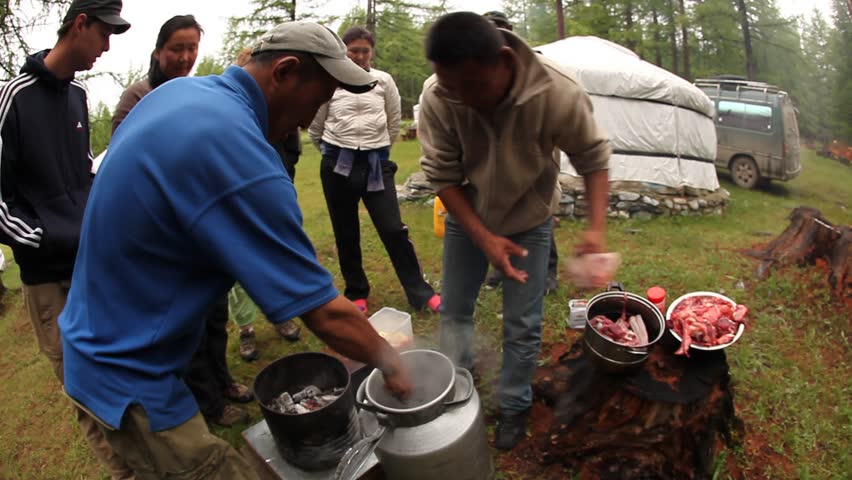 MONGOLIA - JULY 17, 2009: Locals cook a stone stew outside on July 17, 2009 in Mongolia.