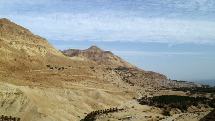 Still shot facing north along the east side of the Ein Gedi mountains west of the Dead Sea in Israel.  An orchard and a habited oasis can be seen at the foot of the Barren mountains.  02/27/2011
