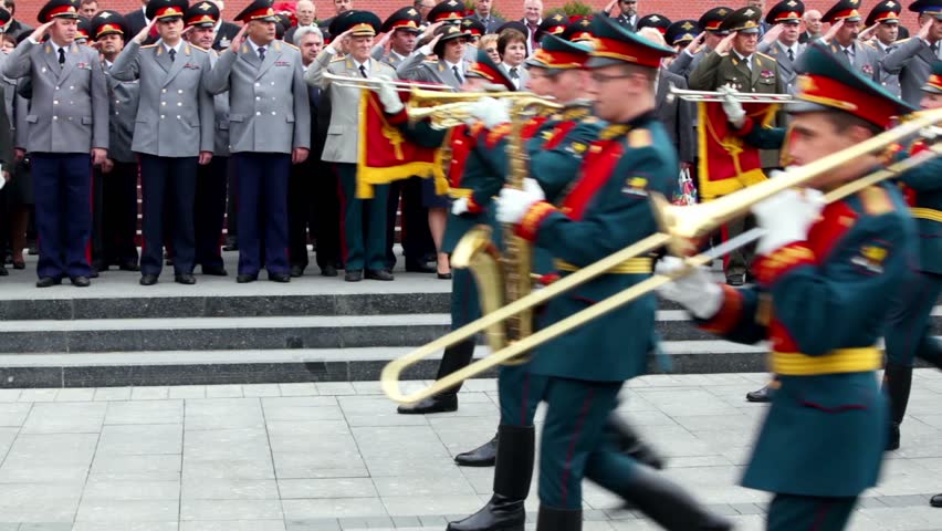 MOSCOW - MAY 8: Interior Ministry officials salute, military orchestra play and march at foreground on May 8, 2011 in Moscow, Russia