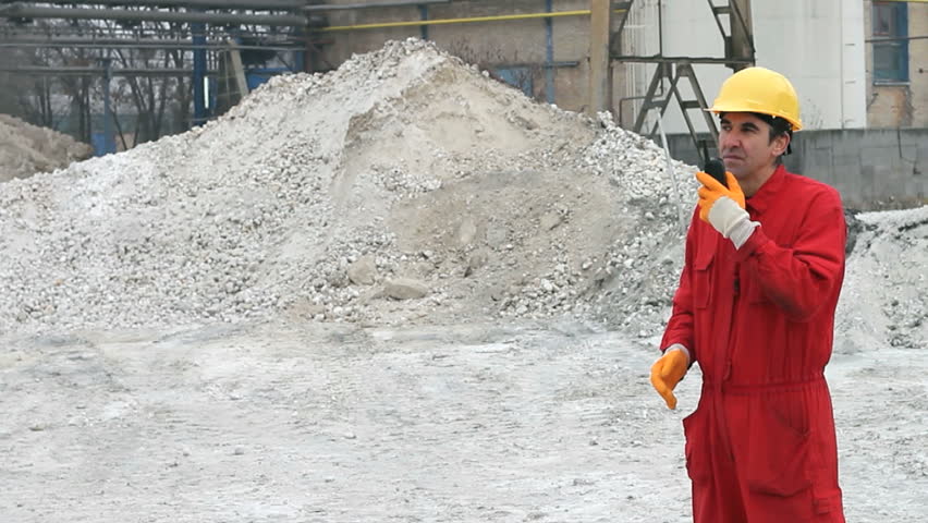 Worker supervising the work of the bulldozer in the factory. HD 1080i.