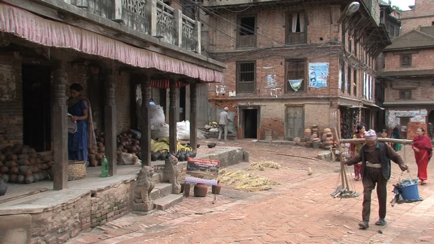 NEPAL - CIRCA MAY, 2011: Men balance baskets on their shoulders. 