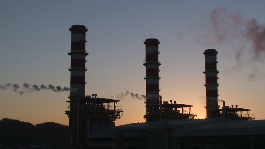 Complex of oil refinery factory at sunset
