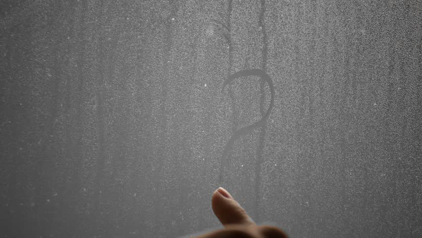 Doodles. Hand draws a question mark and Valentine heart on steamy window. 