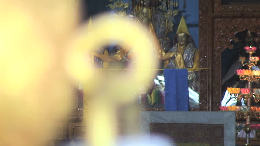Focus from Tibetan Buddha to Door Handle, India