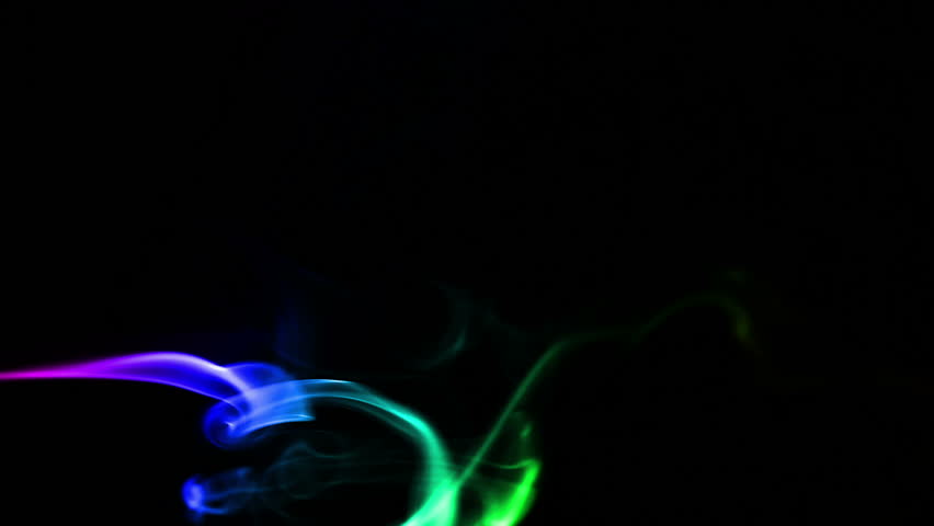 Multicolored smoke forming waves on Black background
