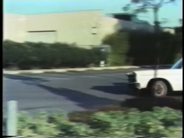 Car hitting policeman and crashing  into parked car