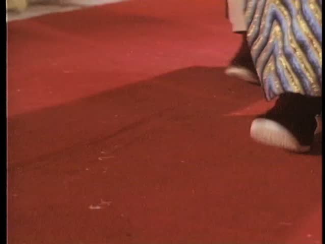 Close-up feet pacing in Chinese slippers
