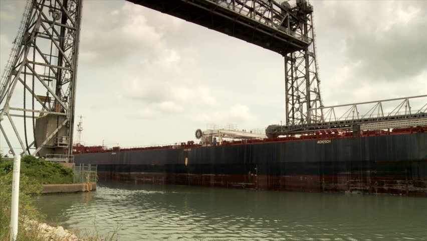 Ship moving under Vertical Lift Bridge along the Welland Canal toward Lake Ontario, Welland, Ontario, Canada.
