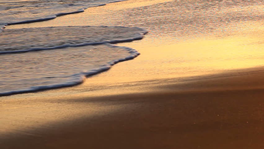 Waves Washing up on Beach at Sunset in Hawaii