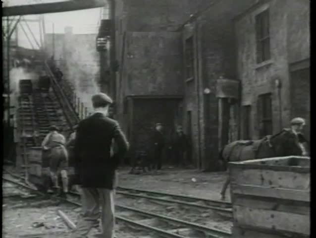 Rear view of men working in coal mine