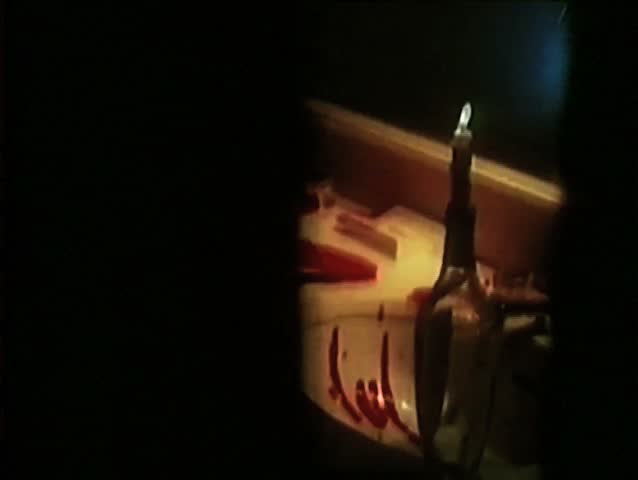 The words I love you written on mirror above bloody sink
