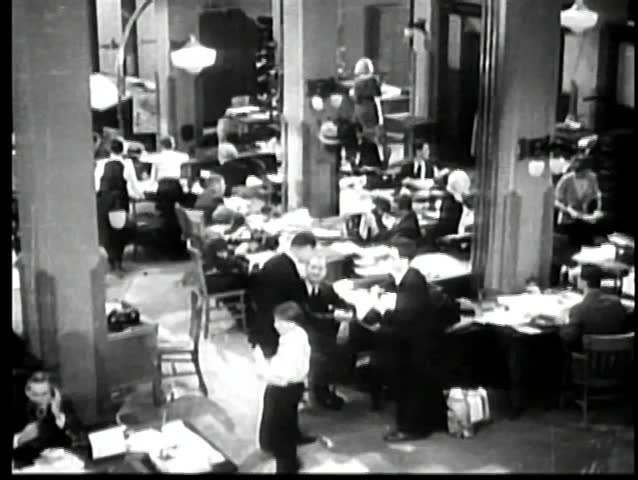 High angle view of two employees clowning around in busy office