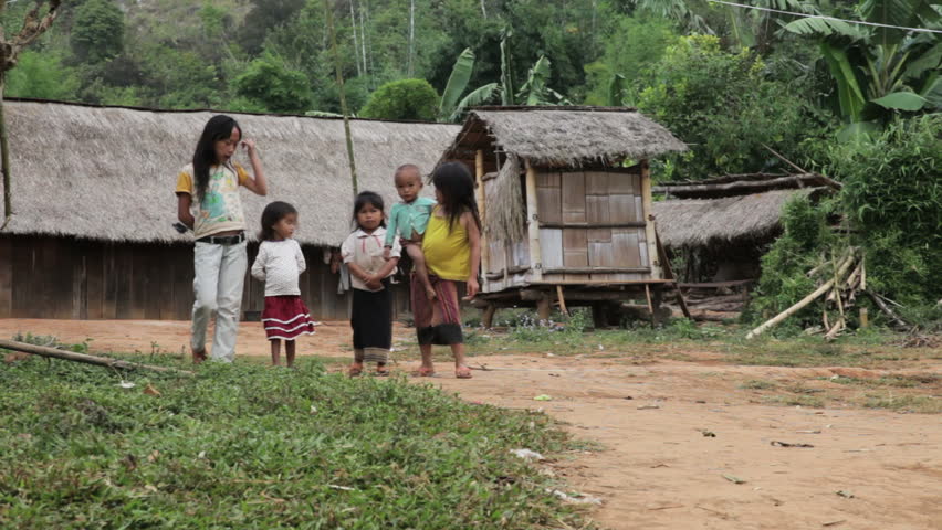 PHONSAVAN, LAOS - OCTOBER 29: Five Hmong ethnics kids walk and laugh in their village in Laos on October 29, 2011.