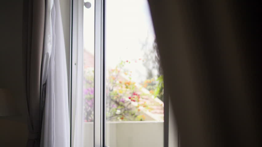 Young business man relaxing and drinking a cup of tea during coffee break and looking out of window