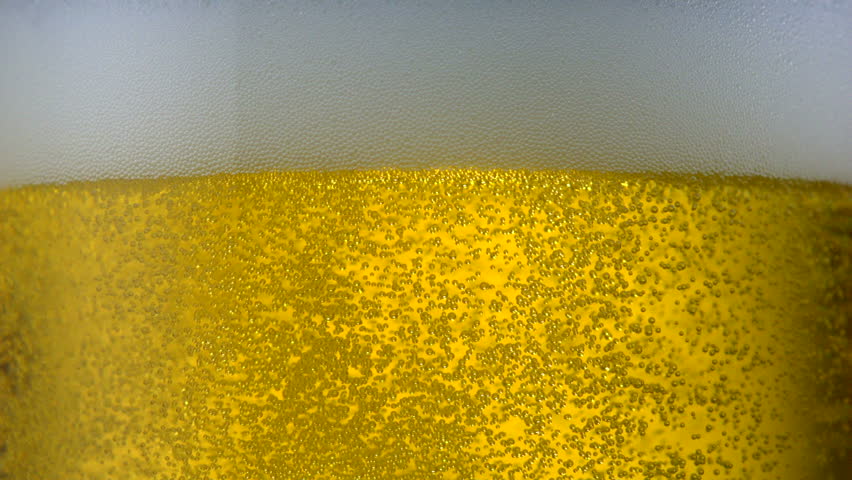 Extreme close-up beer bubbles in glass