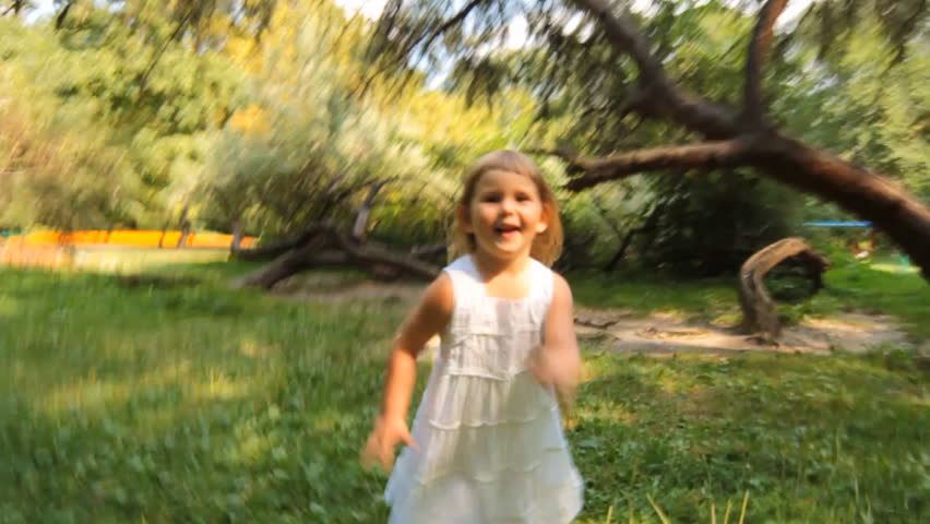 3-year-old girl runs in a park