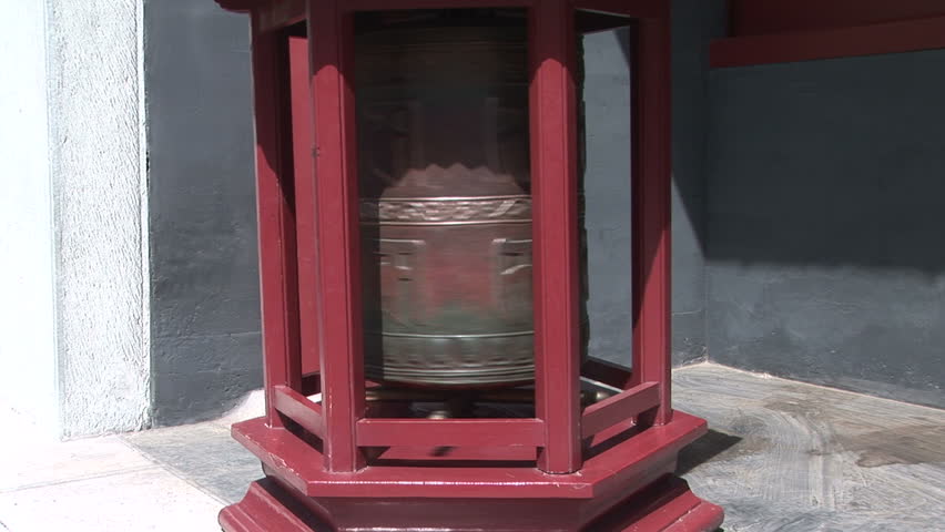 Bronze prayer wheel spinning in the Lama Temple, Beijing, China, zoom in
