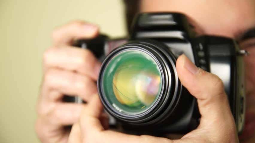 Photographer takes pictures with DSLR camera.