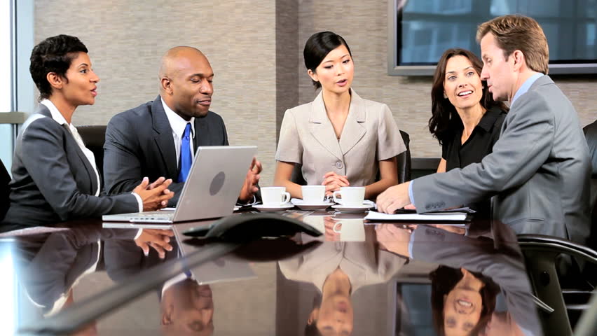 Female asian chinese business executive in a boardroom meeting with her multi ethnic business team