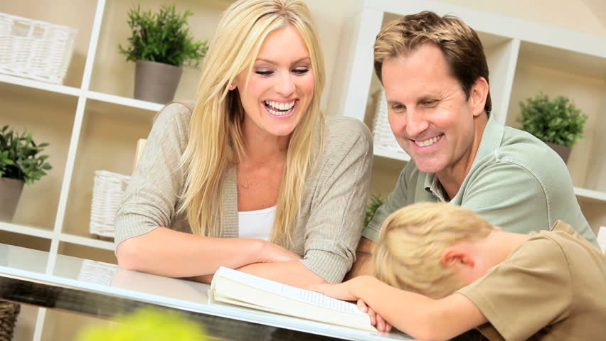 Young caucasian boy talking to his parents about the book he has been reading