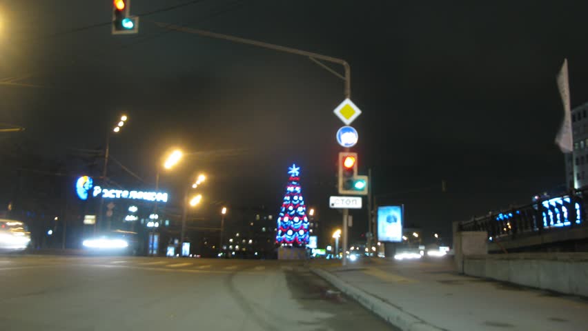 MOSCOW - NOV 11: (Timelapse View) Cars go, stop and continue driving in city center under nigth lanterns and festive shining garlands, on Nov 11, 2011 in Moscow, Russia.
