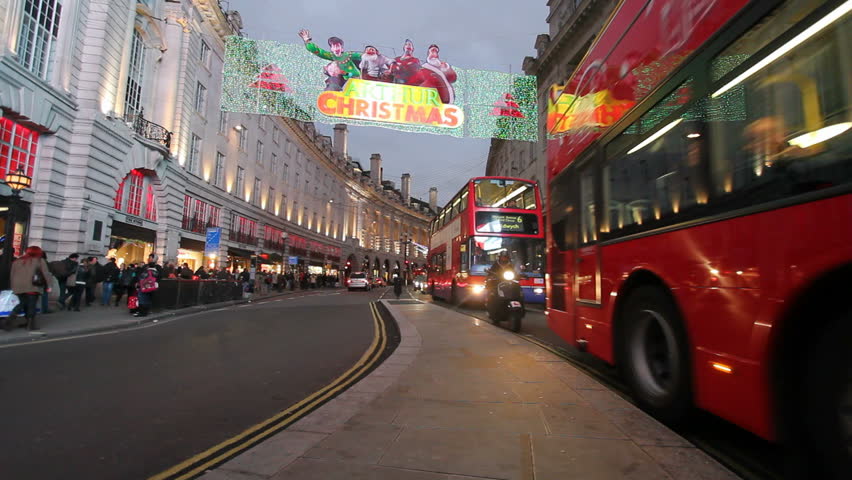 LONDON, UK - DECEMBER 27: Busses and other traffic drive beneath Christmas lights on Regent Street on December 27, 2011 in London, UK. Regent Street is one of the main shopping streets of London.
