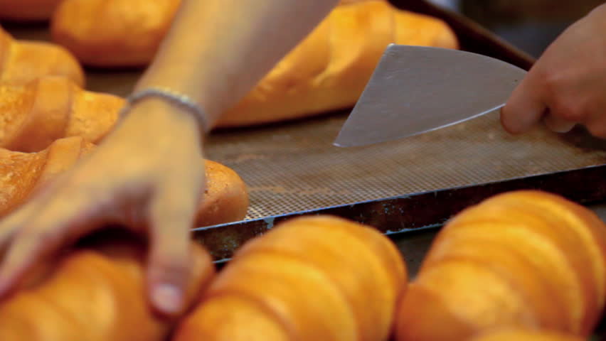 Baker lays out the bread into trays