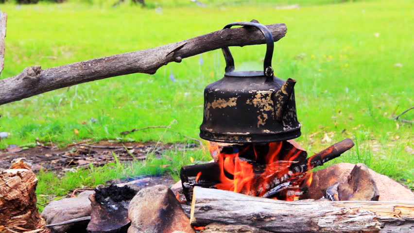 Smoky tourist kettle on fire in camping picnic