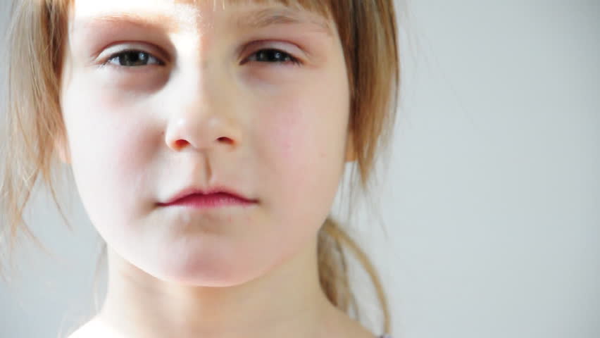 close-up portrait of a serious little girl 