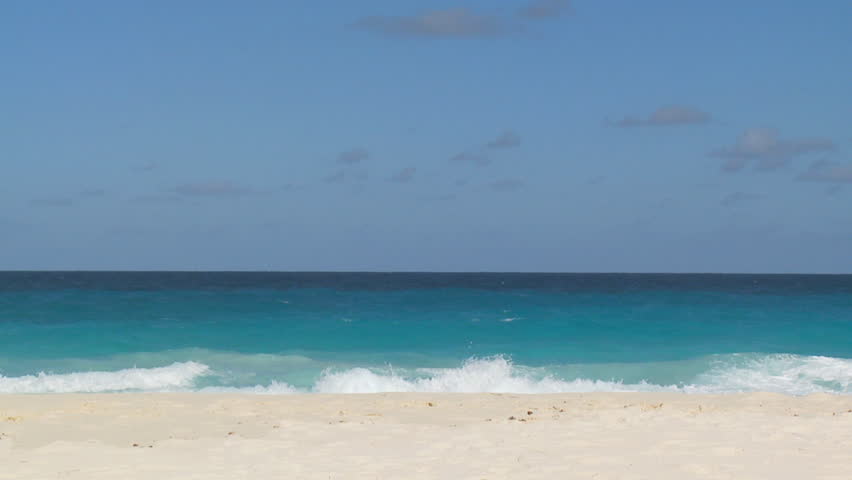 woman in white bikini pivoting on sandy beach, slow motion