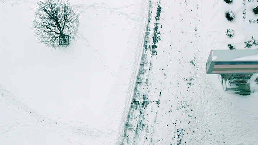 Bird's eye view of the sidewalk and snow plow in action. HD1080p.