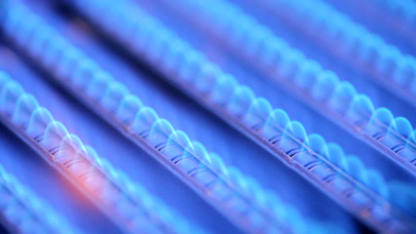 Blue flames of a gas burner inside of a boiler