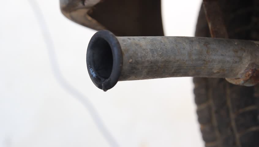 car exhaust dripping and blowing vapor