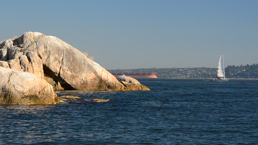 Sailboat and jet crossing in Lighthouse Park at West Vancouver, Canada.